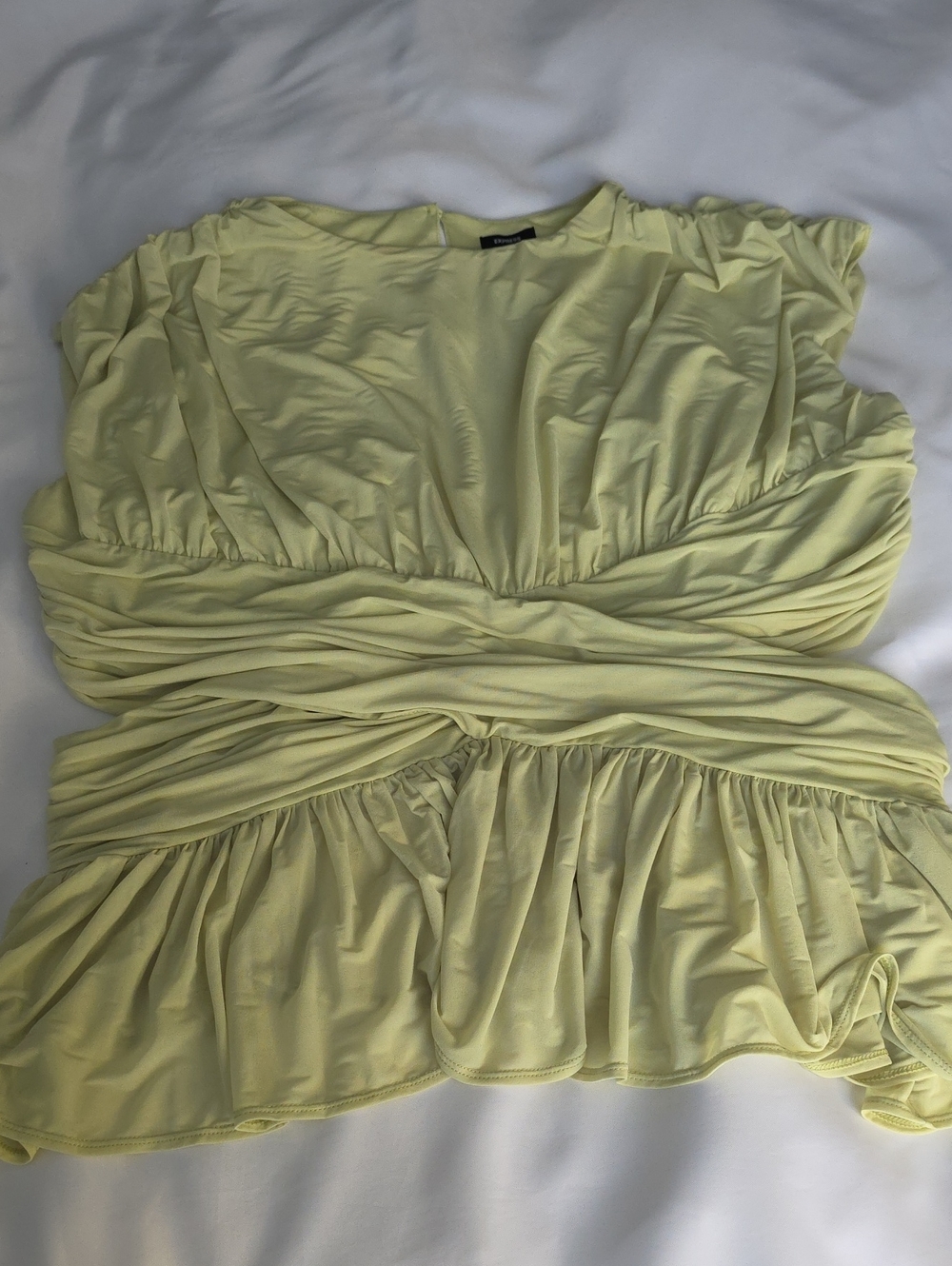 NWT Express Green Ruched Peplum Top feminine and Flirty. Has Cut Out Sides.